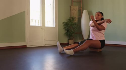 Woman Stretching Arms During Indoor Workout Routine