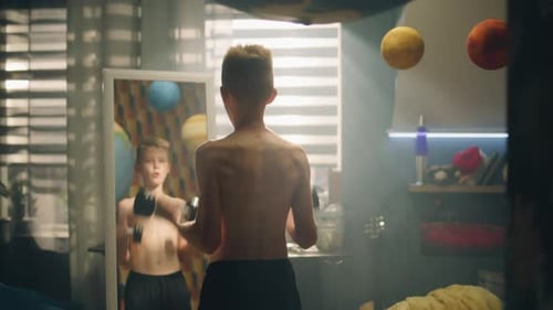 School Boy Do Dumbbells Curls in Front of the Mirror in His Room Nude Upper Body