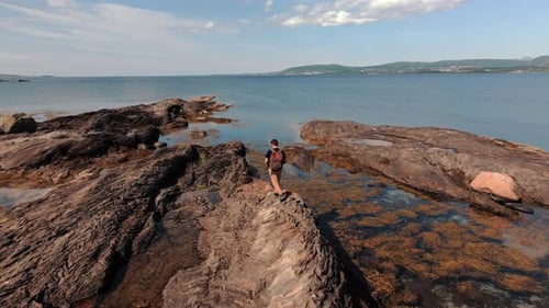 Aerial Views Volcanic Rocky Norway Bathed in Sunlight a Traveler Walks the Stone