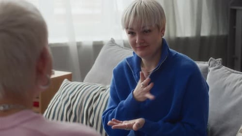 Woman with Short Blonde Hair Conversing Indoors