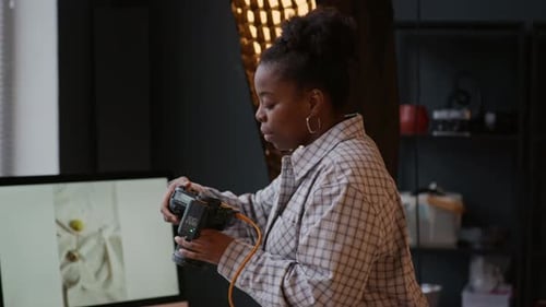 Smiling Woman in Studio Setting Holds Camera