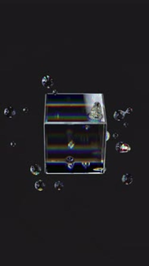 Metaball liquid transparent iridescent blobs with rotating cube.