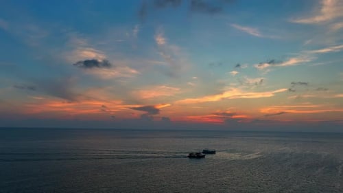 Drone aerial view of endless horizon over the sea in sunset. 4K.