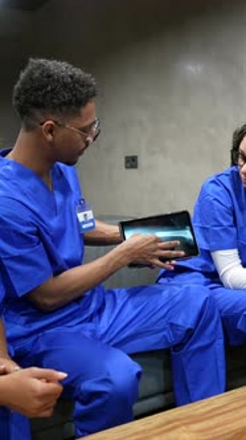 Medical Professionals Reviewing X-Ray Image on a Tablet