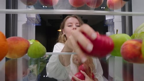 View From Inside the Fridge Woman Opens Side By Side Fridge Doors Puts Tomatos Then Closes It Female