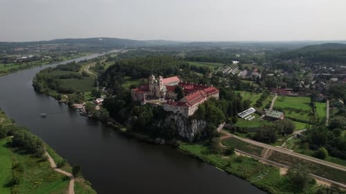 Aerial view of Benedictine abbey on the rocky hill and cliff at Vistula River on a sunny day. Tyniec
