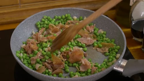 Peas, Onions, and Ham Cooking in a Pan