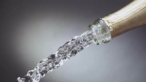 Champagne Pouring Sparkling Liquid from Gold Bottle