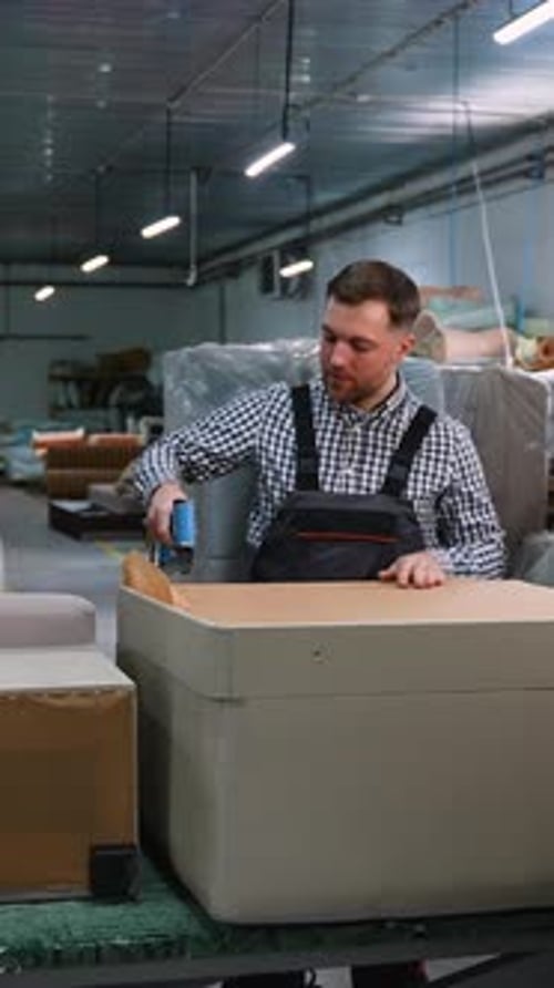 Worker Assembling Sofa Frame in Upholstery Workshop