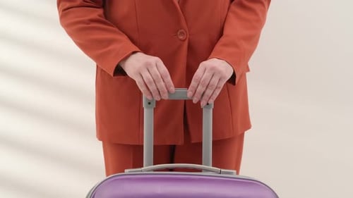 Woman Holding Suitcase Handle at the Airport of Close Up