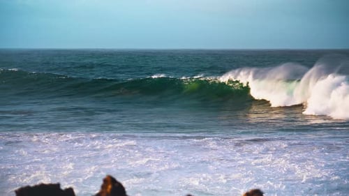 Massive Sea Wave Swelling In Slow Motion. White Foaming Ocean Rolling Towards Rocky Seashore On S...