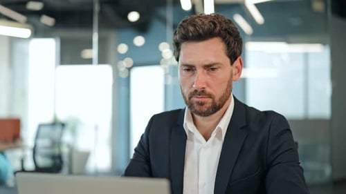 Focused Businessman Thinking In Modern Office