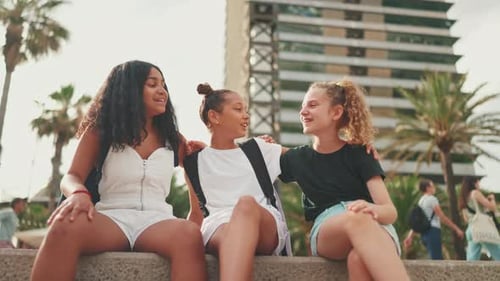 Children Friends Sitting in Urban Setting in Summertime