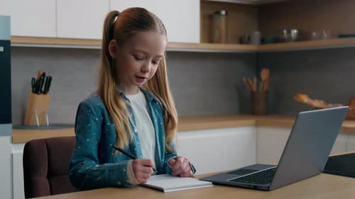 Blonde Girl Studying Online with Laptop at Home