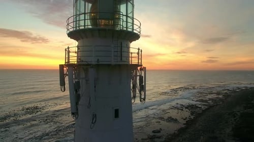 Sunset, drone and ocean with landscape of lighthouse nature, travel beacon and coastal landmark