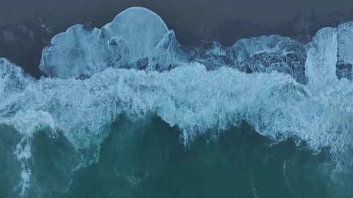 Aerial Video Stunning Foam Textures From Crashing Waves During a Storm on the Beach