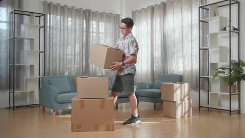 Man Unpacking Boxes in Sunny Living Room
