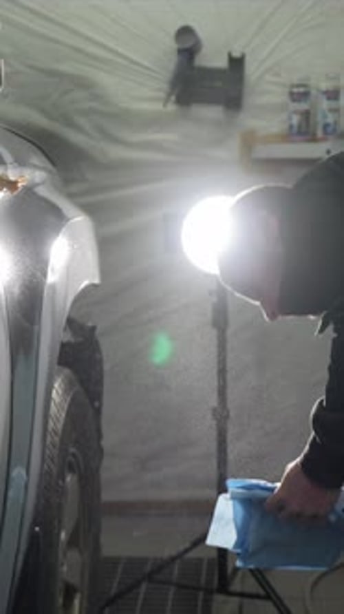 Mechanic Degreasing Car Body Fender Before Painting