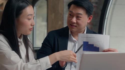 Business Professionals Discussing Data in Modern Workplace