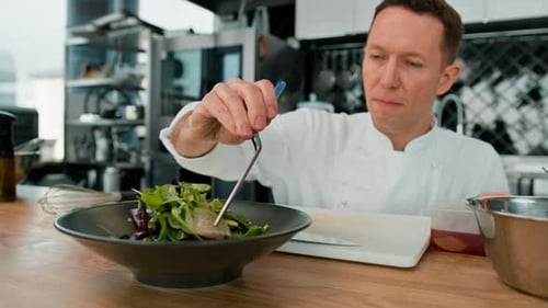 Chef Assembling Salad in a Restaurant Kitchen
