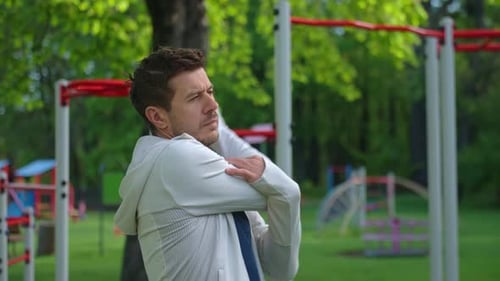 Man Stretching Before Outdoor Workout in Park Athlete Prepares for Training