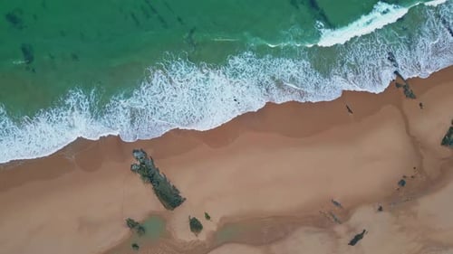 Aerial Waves Foaming Shore View Sand Meeting Lush Green Seawater From Above