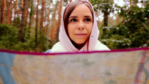 Cute Girl Reading Map in Forest