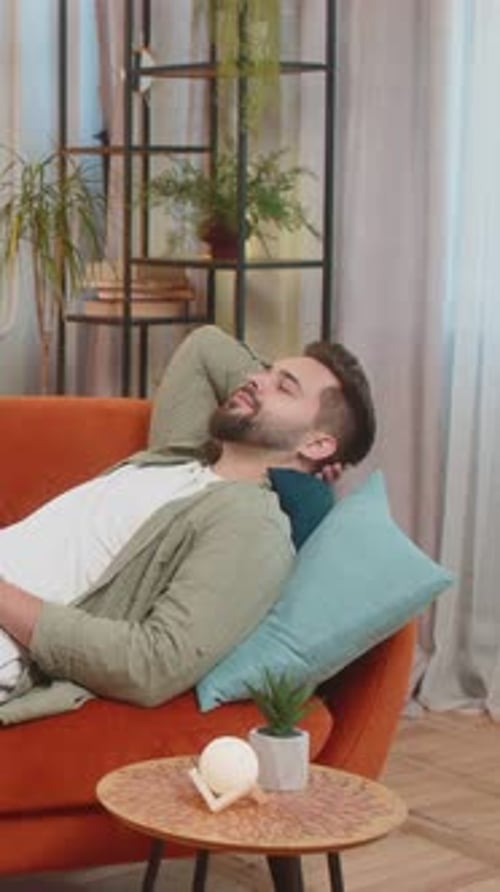Man Relaxing on Couch in Home Setting