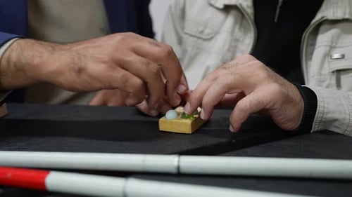 Hands working together with toy building block