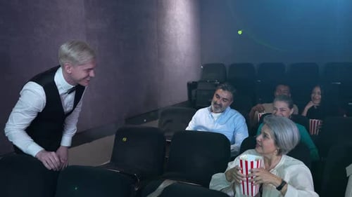 Group of People in a Movie Theater Talking