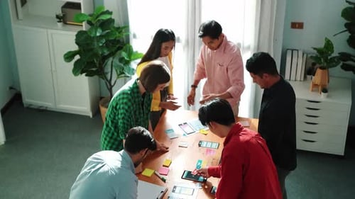 Top view of developer group planning for digital wireframe design. Convocation.