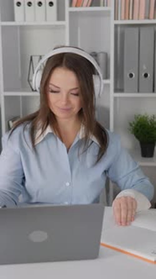 Young Female Freelancer Working on Laptop in Her Home Office While Doing Various Online Work Tasks
