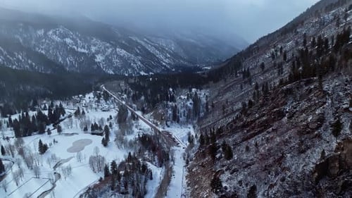 Snowy mountain valley landscape panorama winter forests and dramatic alpine peaks