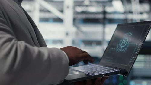 Server Farm IT Expert Using Laptop to Improve Deep Learning AI Systems Closeup