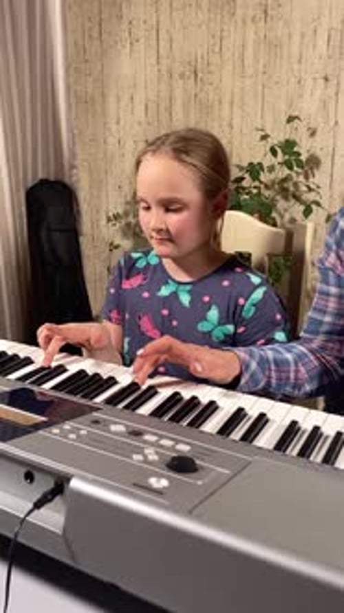 Child Learns Piano with Instructor at Home