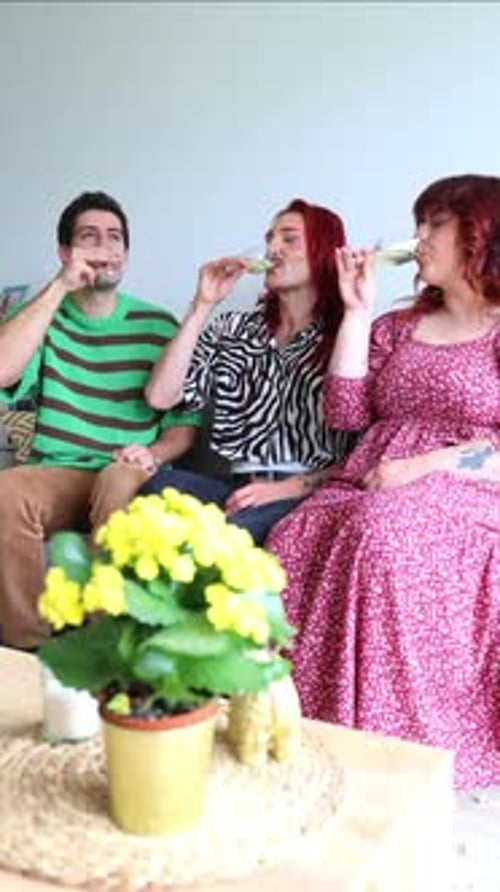 Non-binary person and curvy woman drinking white wine vertical