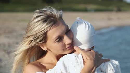 Loving Mother Holding Baby at the Beach