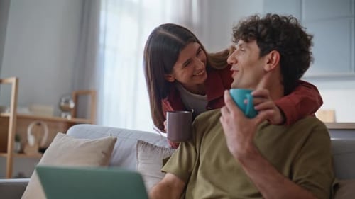 Young Couple Works on Laptop at Home