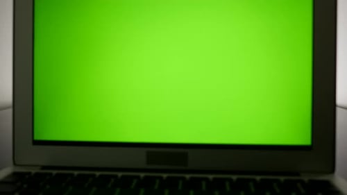 isolated green screen on laptop computer display. modern office desk table view