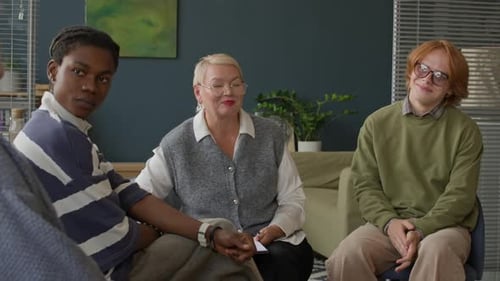 Group Therapy Session with Counselor and Young Adults