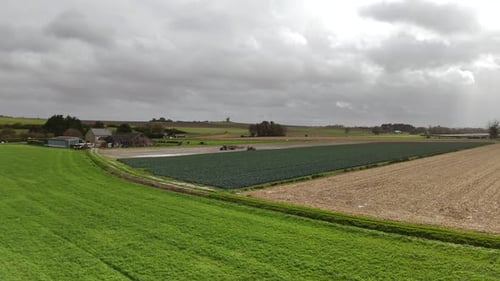 crop drone view with agricultural tractor