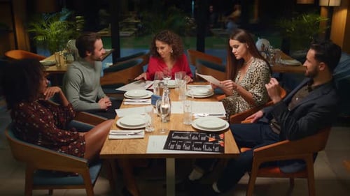 Diverse friends enjoying pleasant conversation together at a luxury restaurant