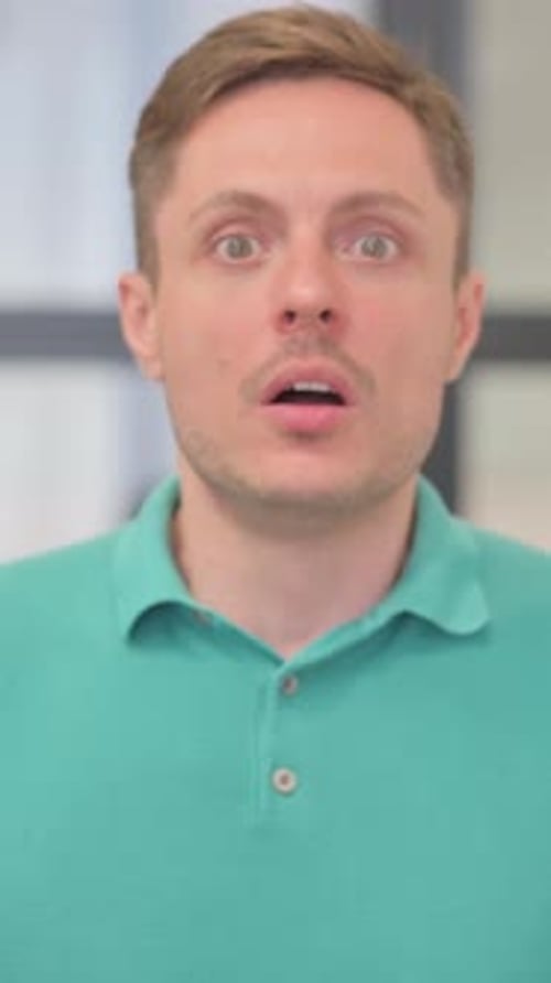 Man with Brown Hair Shows Surprise Reaction Close Up