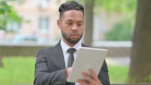 Man in Suit Using Tablet Outdoors