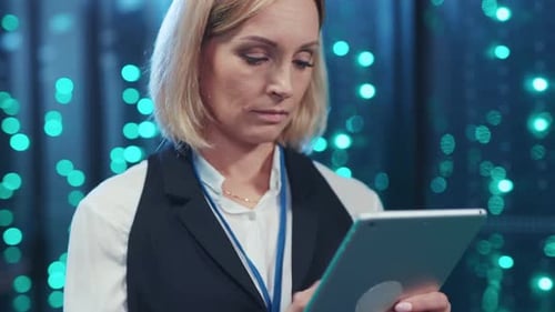 Woman in Server Room Using Digital Tablet