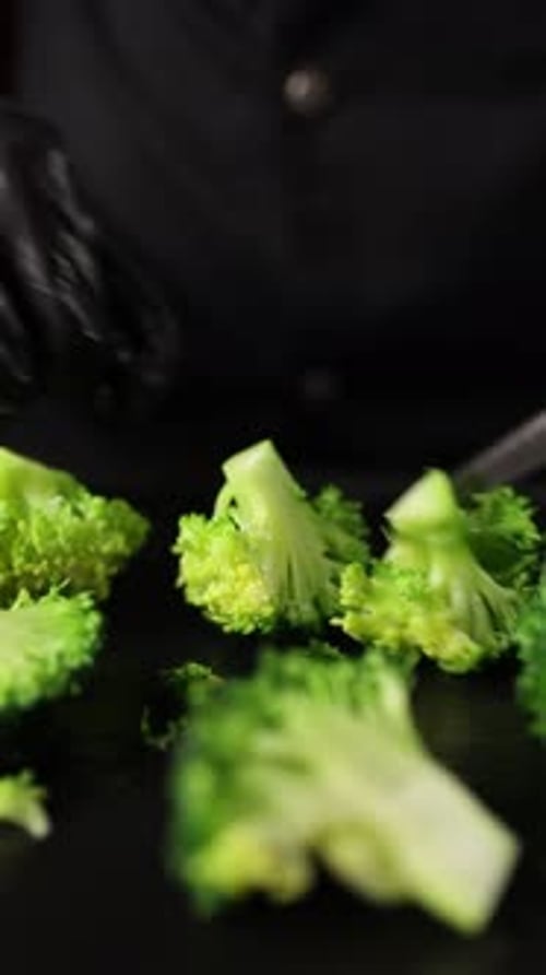 The chef prepares a vegetable dish. Cooking broccoli