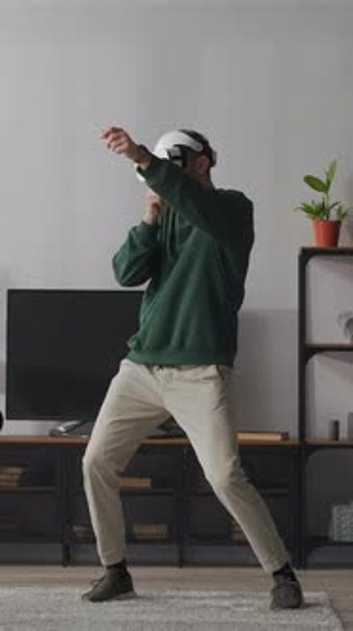 Man in VR Headset Shadow Boxing in Apartment