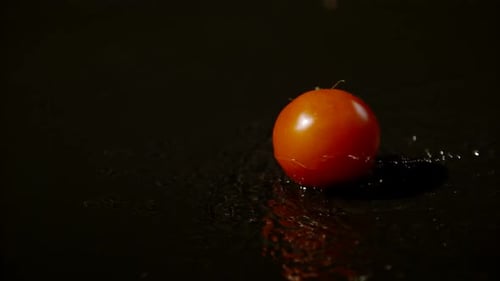 Shiny Red Tomato Splashing in Water