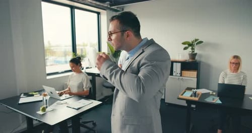 Confident businessman with coffee standing in a modern office