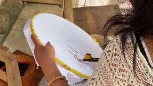 Woman Works on Fabric Embroidery with Tool